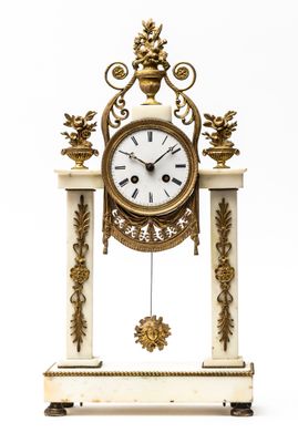 a white and gold clock on a stand on a white background