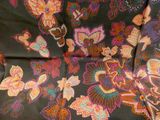 an image of a close up of a chair covered in a colorful floral pattern