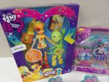 a box of toys that includes a doll and a figure
