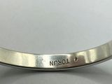 a close up of a silver bracelet with a name engraved on it