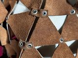 a close up of a brown and white object with holes