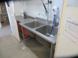 a kitchen with a sink and a faucet in it