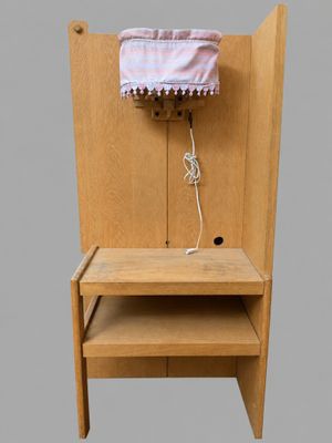 a wooden chair with a shelf and a lamp on it