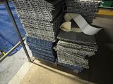 many stacks of fabric on a metal rack in a warehouse
