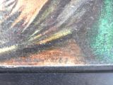 a cat that is sitting on a bench in front of a painting