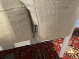 a close up of a chair with a red rug on the floor