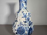 a blue and white vase sitting on a table