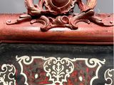 a close up of a clock with a decorative decoration on it