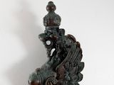 bronze statue of a bird with a crown on its head