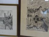 two framed pictures on the wall of a room