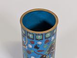 a blue vase with a design on it on a white surface