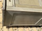 a wooden cabinet with a drawer on top of it
