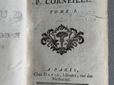 an open book with a black and white image of a coat of arms on it