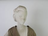 a statue of a woman with a scarf on her shoulders
