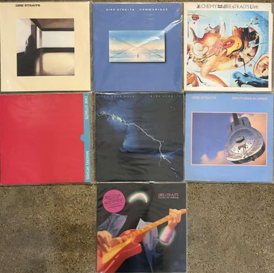 several albums of various music are arranged on the floor