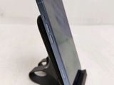 a close up of a cell phone on a stand on a table