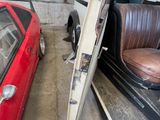 a red car parked next to a red car in a garage