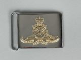 an image of a silver and gold belt buckle with a picture of a man on a horse