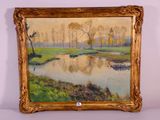 une image représentant un tableau représentant une rivière et des arbres, dans un cadre doré