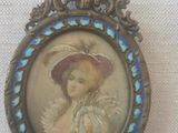an old picture of a woman wearing a hat and a blue and white dress