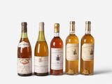 several bottles of wine are lined up on a white surface