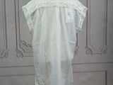 an image of a white shirt on a mannequin stand