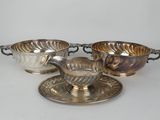 three silver plated bowls and saucers on a saucer