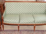 two couches that are sitting next to each other in a room