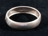 a close up of a silver ring on a black surface