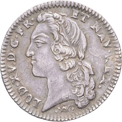 gros plan d'une pièce de monnaie sur laquelle figure un visage de femme