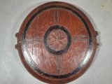 a wooden shield with a star on it on a table