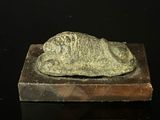 a statue of a fish on top of a wooden block