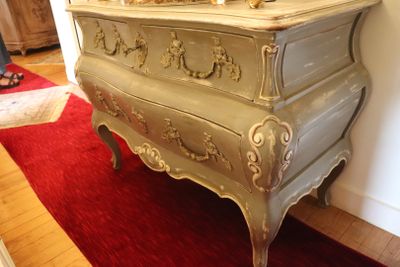 a dresser with a mirror on top of it in a room