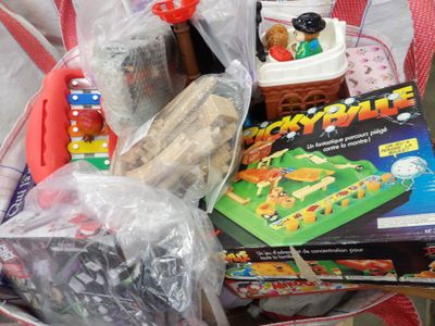 a basket full of toys and books sitting on a table