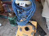 a yellow machine that is sitting on the ground next to a couch