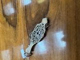 a small metal object on a wooden table