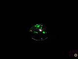 an oplite in the dark with a green glow on it