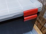 two plastic boxes with lids on top of each other