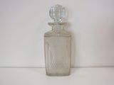 a glass bottle with a clear top on a white surface
