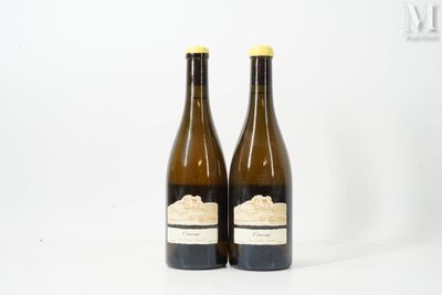 two bottles of wine sitting next to each other on a white surface