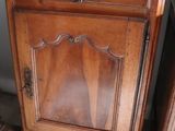 a wooden cabinet with a mirror on top of it