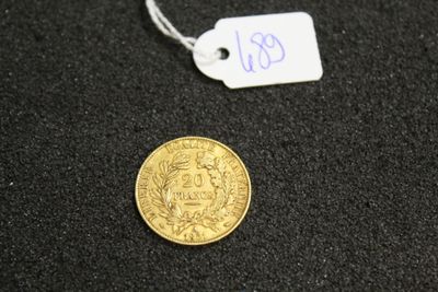 a close up of a coin on a black surface with a price tag