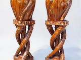 two vases that are made of wood and have twisted stems