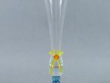 a clear glass vase with a red base and a yellow base
