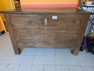 a wooden chest sitting on a tiled floor in a room