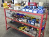 a red shelf with many items on it in a warehouse