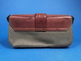 an image of a brown and grey purse on a blue background