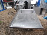 a stainless steel sink in the middle of a room