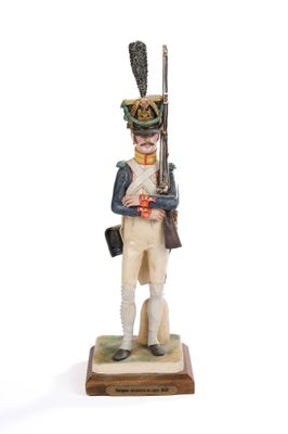 figurine of a soldier holding a rifle and a rifle