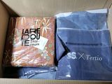a box of clothing and a bag of clothing inside of it